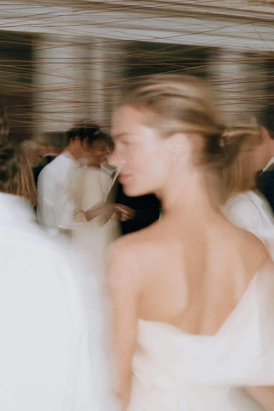 A member in white turning through a busy room